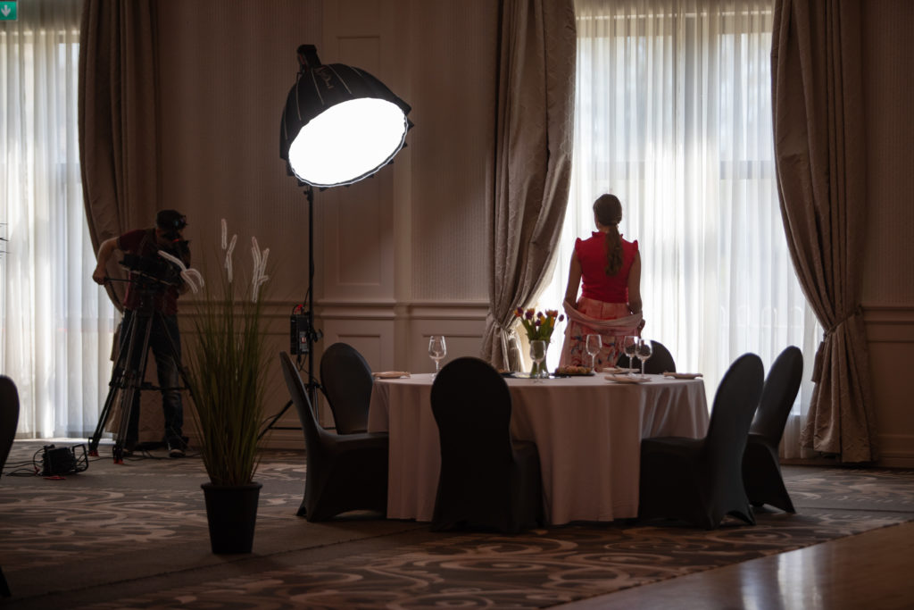 Luxurious Hotel Dining Room Elegant dining room with plush decor, stylish round table, and exquisite window view, creating a serene dining experience.